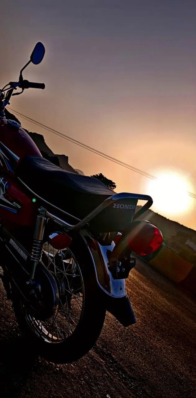 Honda 125 with sunset