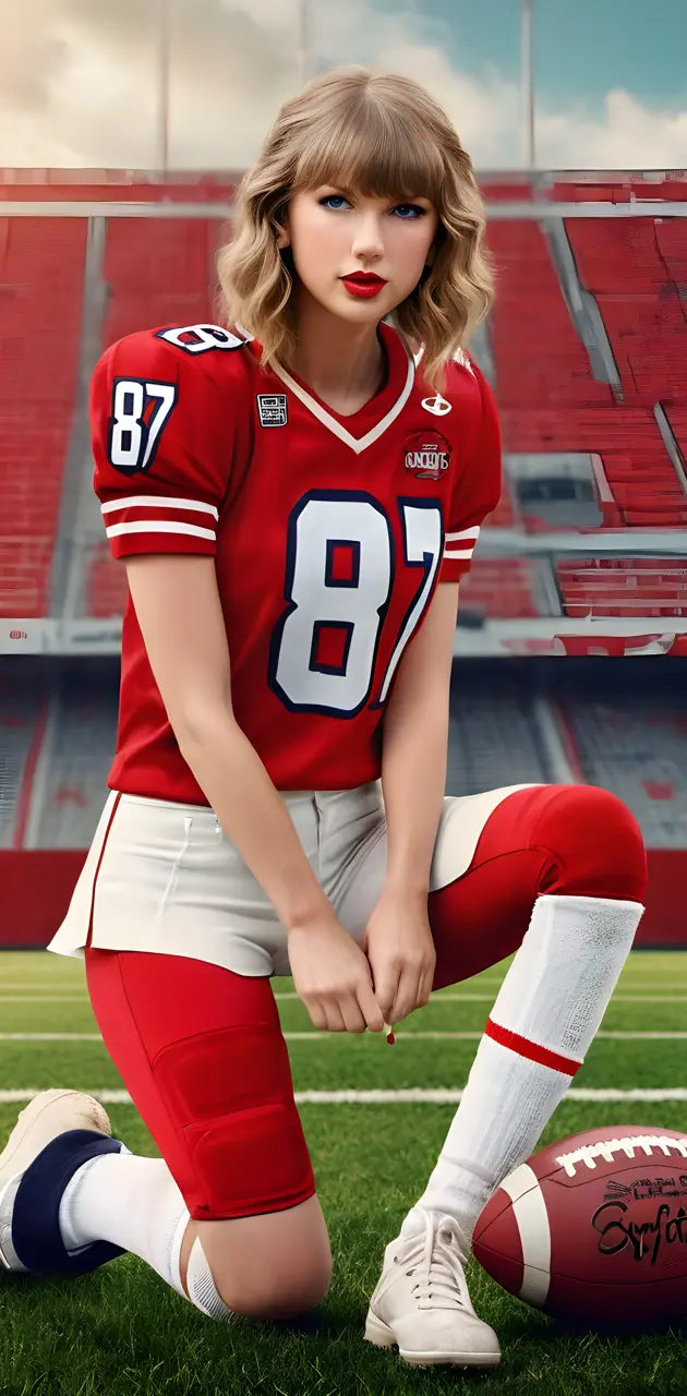 Taylor Swift in a sports uniform sitting on a field